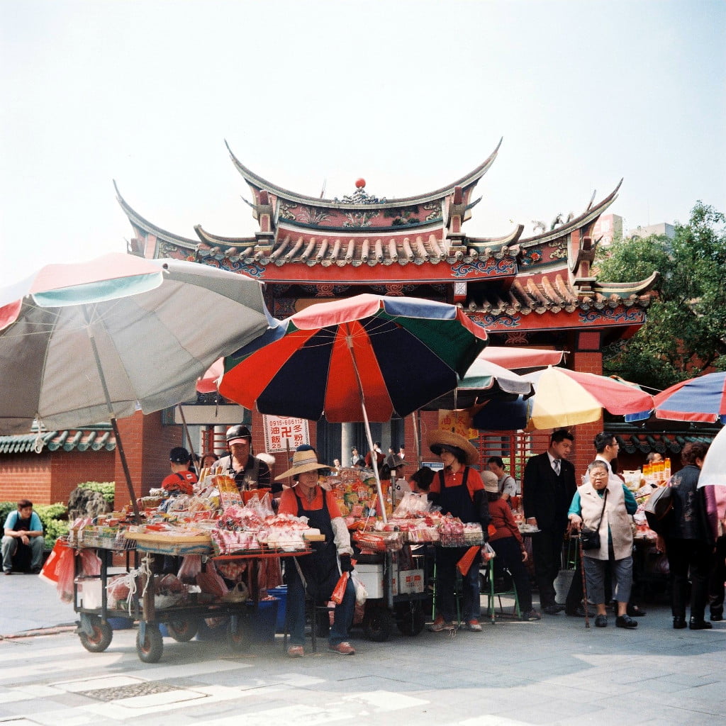 Old lady selling incense in front of Xingtian Temple, Taipei City.